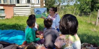 Într-un sat din Timiș: La umbra unui copac, pe pături, zeci de copii se strâng de două ori pe lună în jurul ”Cufărului cu povești” FOTO